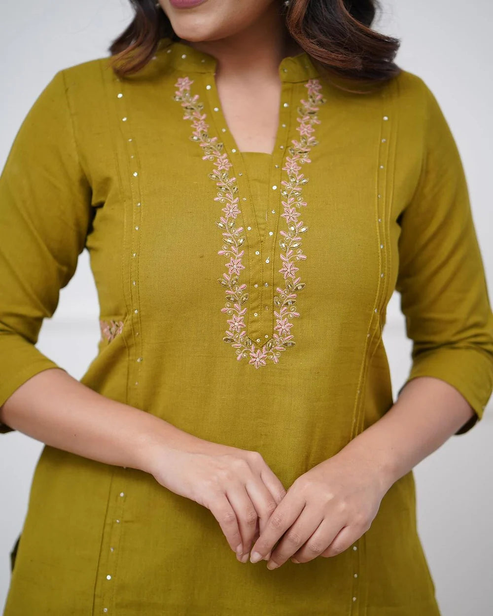 Pure cotton pleated pattern kurta with heavy embraided panels and sequence work.